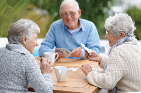 Three friends playing cards