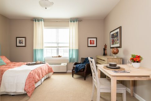 large angle view of orange comforter bedroom